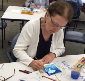 Marian Wiseman works on her greeting card